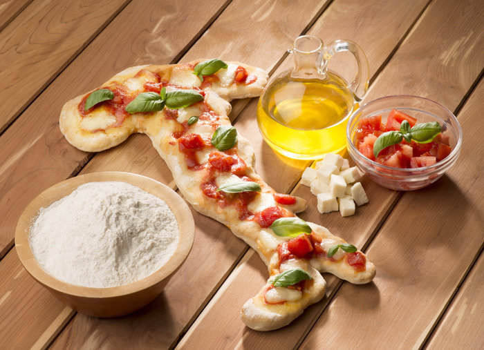 Italia a forma di pizza che racchiude le sigle dei prodotti di qualità DOP IGT